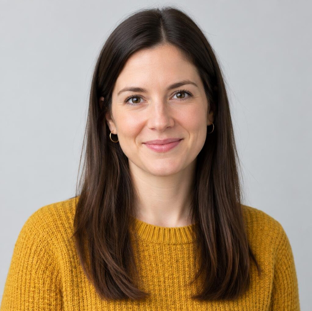 Studio portrait of a young German woman with dark hair wearing a knit sweater