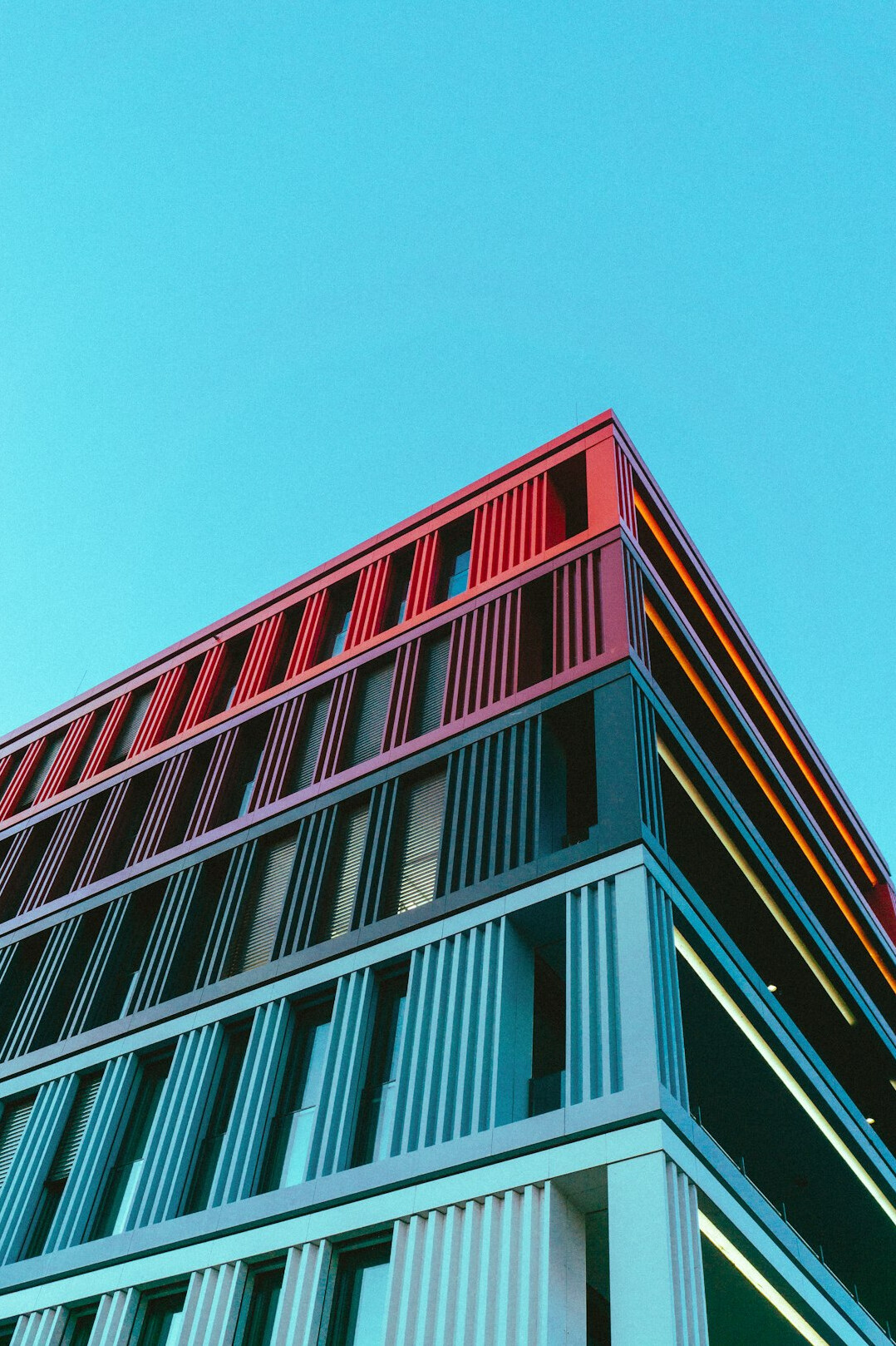 Modern glass office building facade in a German city under a clear sky